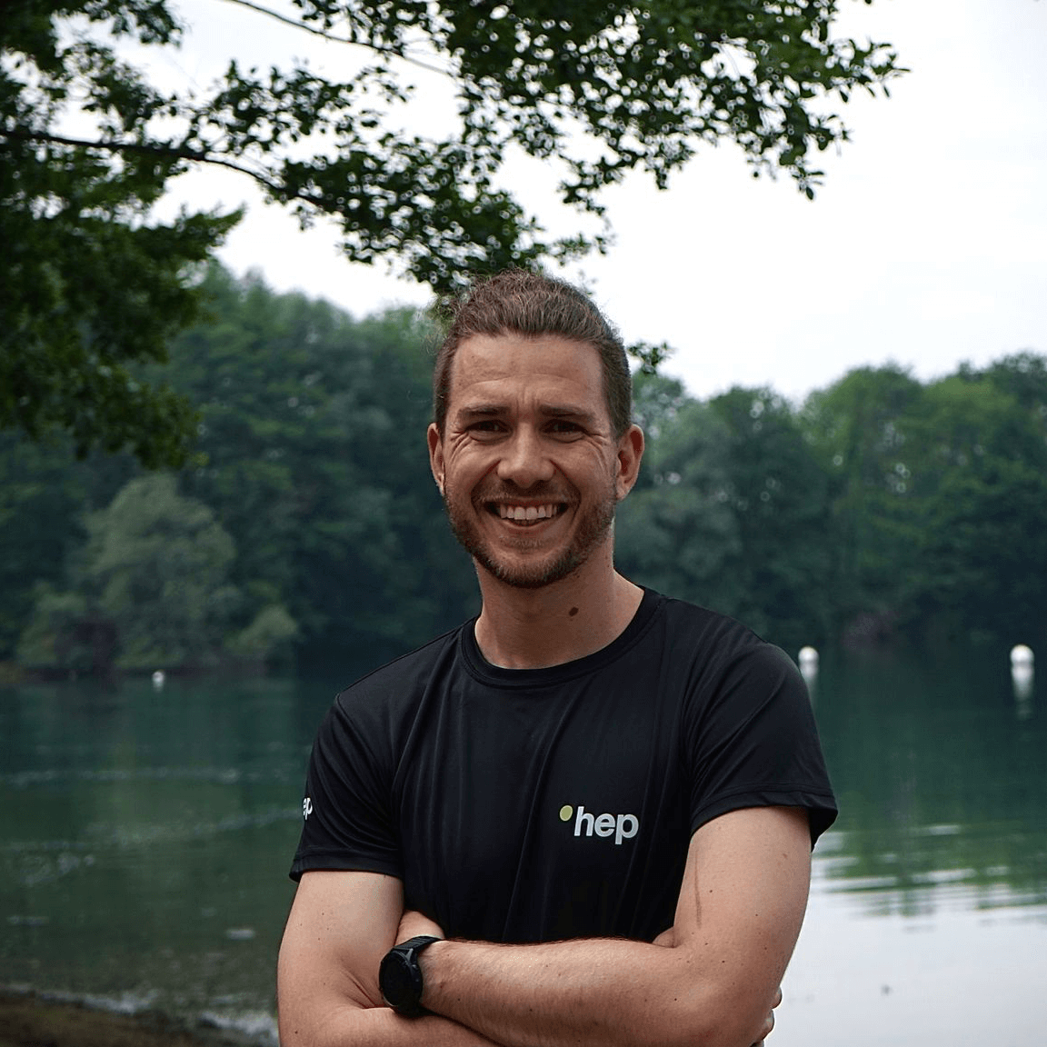 Profile picture of a smiling man, lake in the background