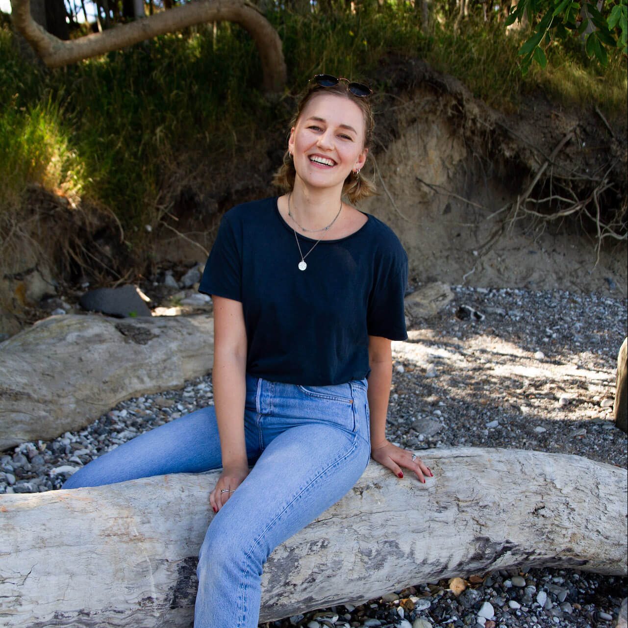 girl smiling stone beach