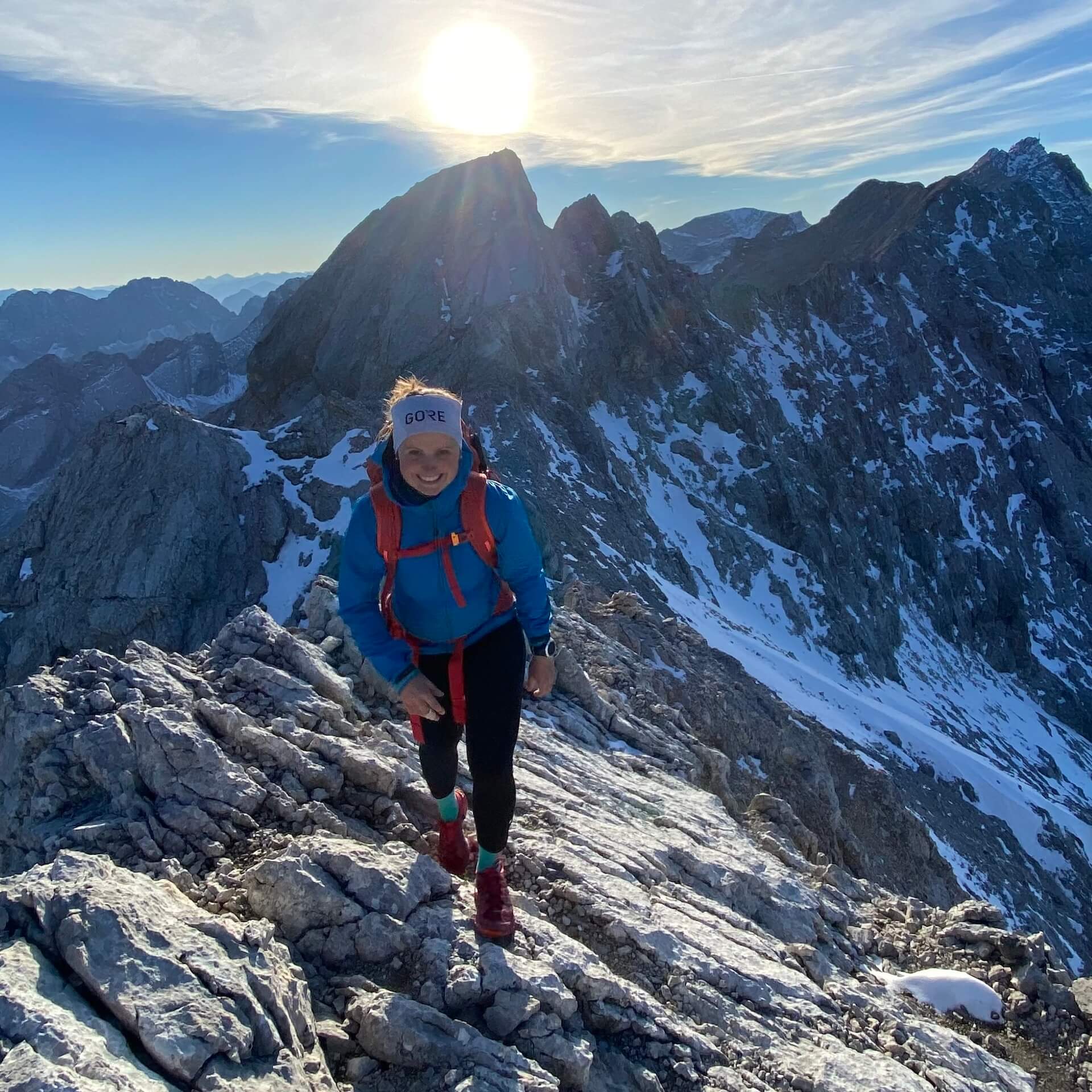 XtraMile athlete woman hiking mountain landscape smiling